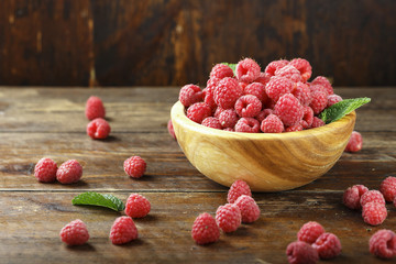 Fresh raspberry in a wooden plate