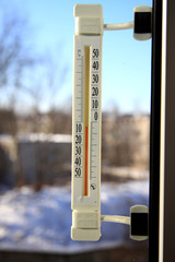 Thermometer on the window showing the temperature on the street.