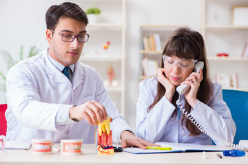 Dentist explaining student tooth structure