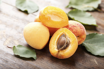 Naklejka na ściany i meble Apricot fruit. Fresh organic apricots on wooden background.