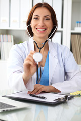 Doctor with  stethoscope in the hands, cheerful smilling. Physician ready to examine and help patient. Medicine, healthcare and help concept