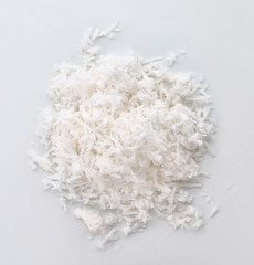 Fresh coconut flakes on white background