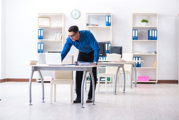 Handsome businessman employee sitting at his desk in office