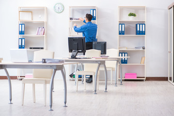 Handsome businessman employee sitting at his desk in office