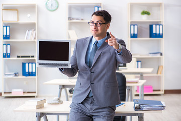 Young handsome businessman employee working in office at desk