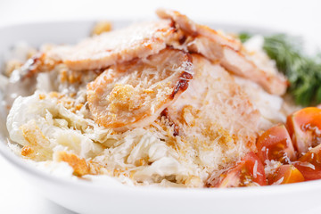 Caesar Salad with chicken . Comprises iceberg lettuce Leaf and croutons dressed with parmesan cheese. White light background