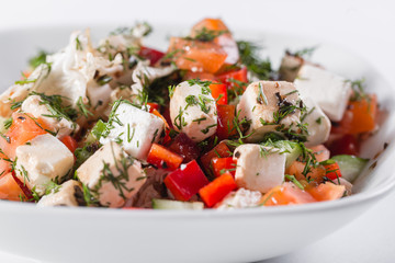 Greek salad. Vegetable with cheese, green salad, with cherry tomatoes, fetta cheese, red onion, and mixed greens