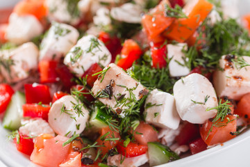 Greek salad. Vegetable with cheese, green salad, with cherry tomatoes, fetta cheese, red onion, and mixed greens