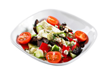 Greek salad. Vegetable with shitake mushrooms, green salad, with cherry tomatoes, fetta cheese, red onion, and mixed greens
