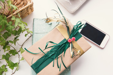 Book and gift box with ribbon decoration on the table