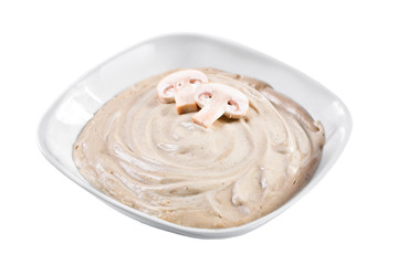 Delicious mushroom cream soup with mushrooms champignon and potato in white bowl.