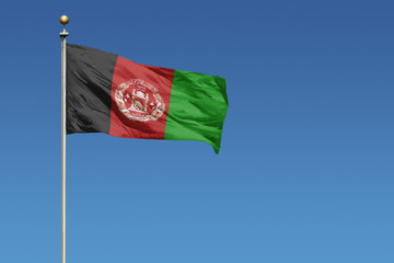 Flag of Afghanistan on a clear blue sky