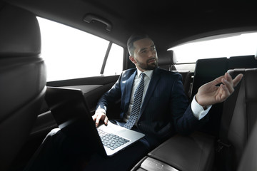 Confident businessman talking in car