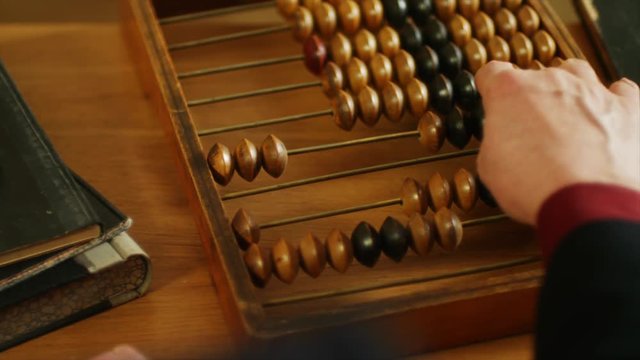 Using abacus or a counting frame on a table