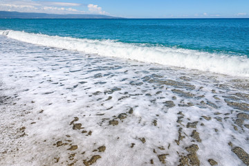 Summer background made of sea and gravel beach