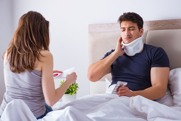 Loving wife taking care of injured husband in bed