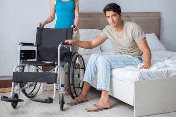 Desperate man on wheelchair with his sad wife