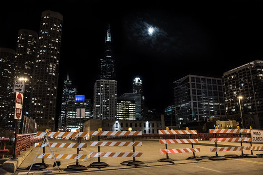 Closed Chicago city street bridge night scene with the Sears Willis Tower skyscraper and the moon