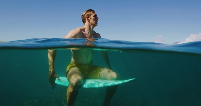 Surfer on beautiful sunny morning, underwater view