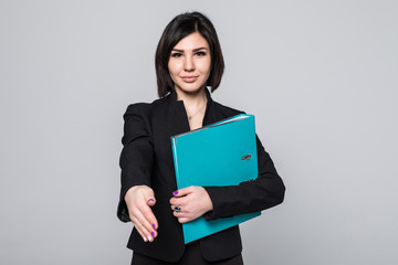 Fototapeta premium Happy young businesswoman holding documents ready to handshake isolated on white background