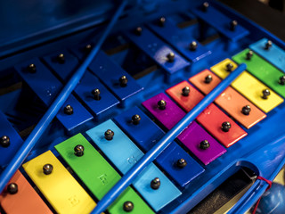 close up toy colourful xylophone instument with sticks on it