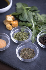 Glass ingredient dishes of dried thyme and spices