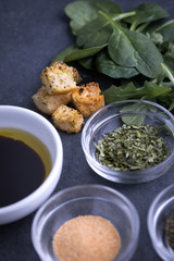 Croutons beside dishes of thyme seasoning and olive oil