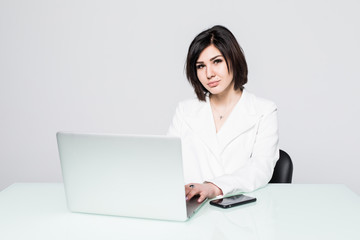 Business woman using laptop at the office, isolated on white