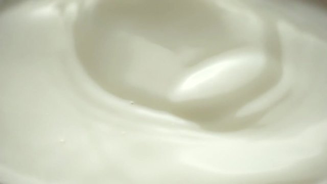 almond falling in the milk closeup - slow motion