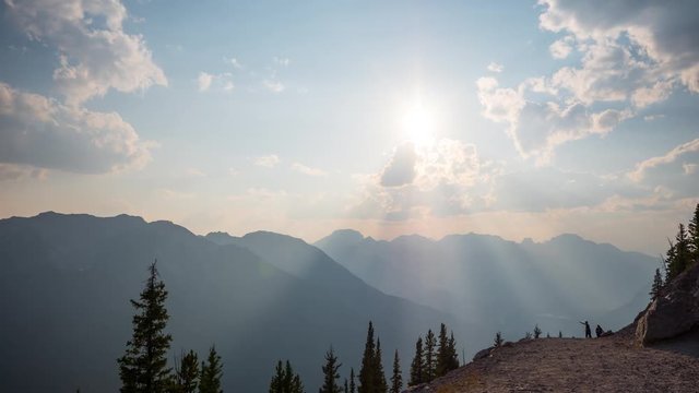 Timelapse of the sun shining over mountains