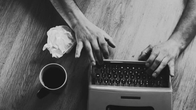 Person typing on a vintage typewriter with vintage 35mm camera, after an adventurous trip, Taking notes and ideas . Different styles available in my gallery color and Black and white