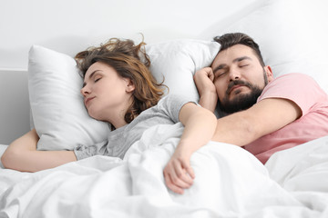 Obraz na płótnie Canvas Husband and wife sleeping in bed at home