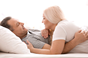 Senior couple in bed together at home