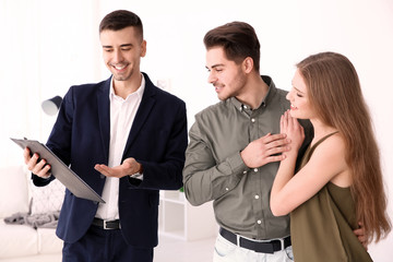 Real estate agent with clients in new house