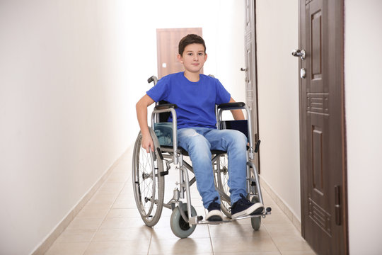 Boy in wheelchair at school corridor