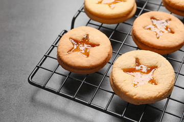 Tasty Linzer cookies with jam on cooling rack