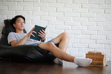 Asian student sitting on pillow and getting ready for exam