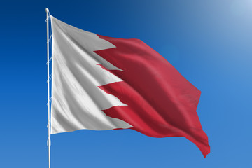 Naklejka premium Bahrain flag on a clear blue sky day