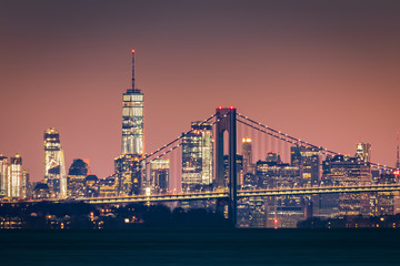 Naklejka premium Manhattan skyline o świcie unosi się za mostem Verazzano