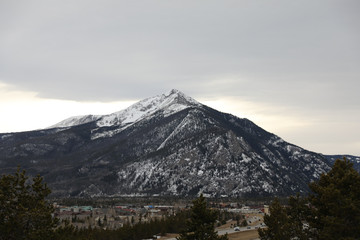 Snow rocky mountains and cloudy weather 