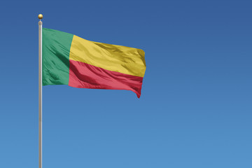 Benin flag in front of a clear blue sky