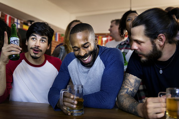 Frieds cheering sport at bar together