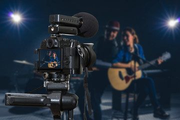 Professional digital Mirrorless camera with microphone recording video blog of Musician duo band...