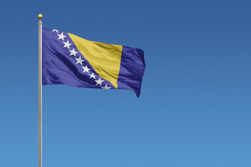 Bosnia and Herzegovina flag on a clear blue sky day