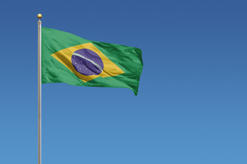 Flag of Brazil in front of a clear blue sky