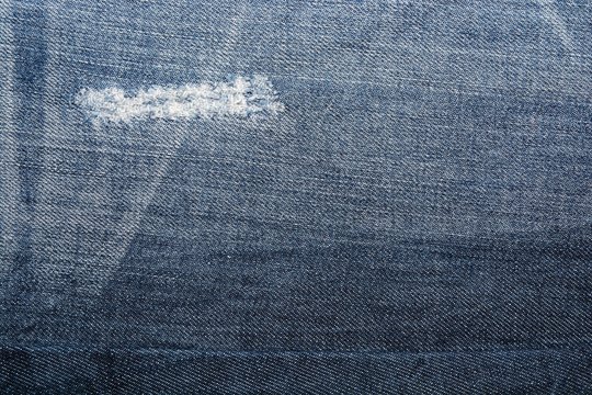 Jean texture with a hole and threads 