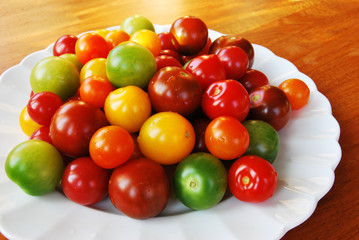 Colorful tomatoes on white plate