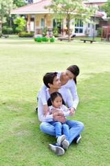 Fototapeta premium Family Concept. Happy male and female playing with children outside. Family is doing happy activities at Playground. Parents are playing happily.