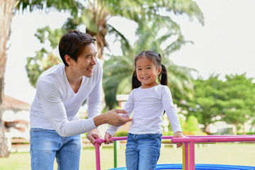 Family Concept. Happy male and female playing with children outside. Family is doing happy activities at Playground.  Parents are playing happily.
