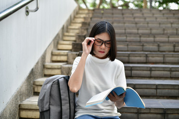 Education Concepts. Asian women reading books in the University. Beautiful women are relaxing in the University. Beautiful women are happy to read. Asian girls love to study. Education of Asian Women.